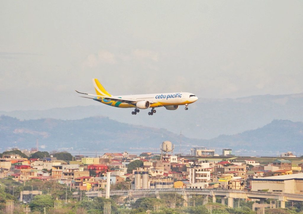 A Cebu Pacific plane landing at NAIA